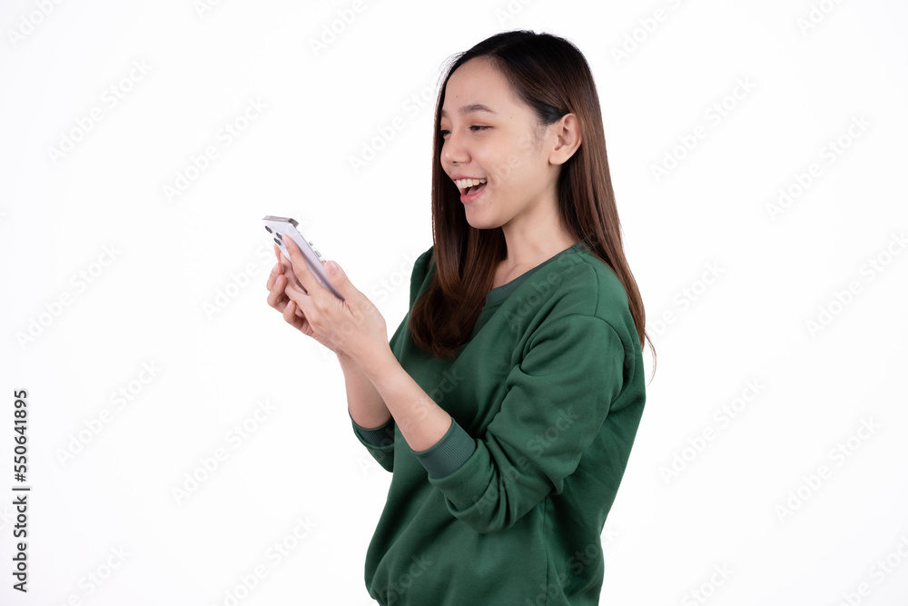 Portrait of a smiling casual asian woman holding smartphone over white background. Portrait of a smiling casual asian woman holding smartphone over white background.