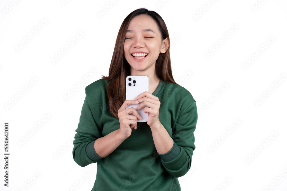 Portrait of a smiling casual asian woman holding smartphone over white background. Portrait of a smiling casual asian woman holding smartphone over white background.