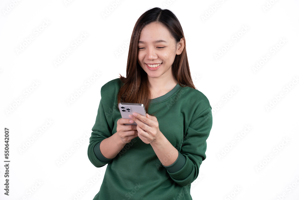 Portrait of a smiling casual asian woman holding smartphone over white background. Portrait of a smiling casual asian woman holding smartphone over white background.
