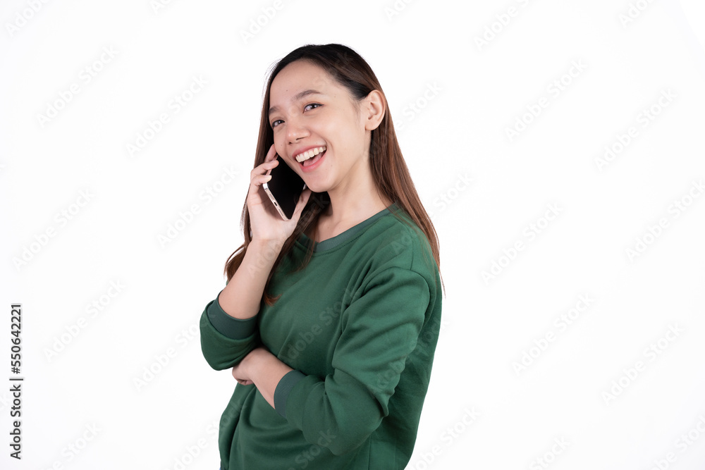 Portrait of a smiling casual asian woman holding smartphone over white background. Portrait of a smiling casual asian woman holding smartphone over white background.