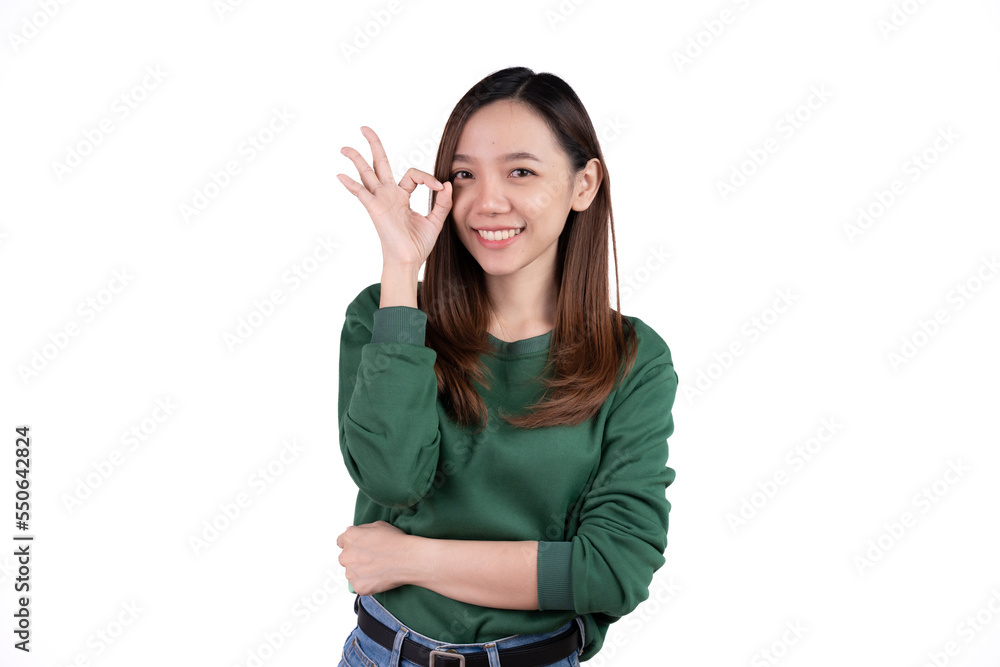 Portrait happy Asian woman shows ok sign and looking at the camera isolated on white background. Portrait happy Asian woman shows ok sign and looking at the camera isolated on white background.