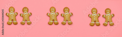 Banner with Christmas gingerbread and Christmas tree branches on a pink background. Place for text on top. The concept of festive New Year s baking