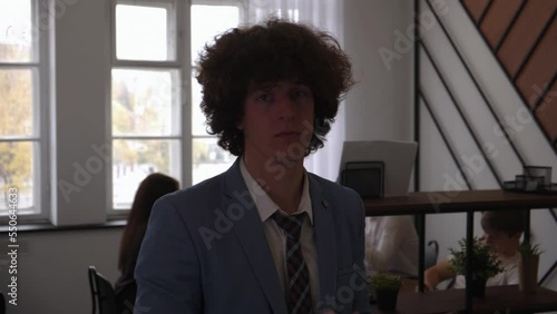 office worker close-up of a man, in the background a working office process