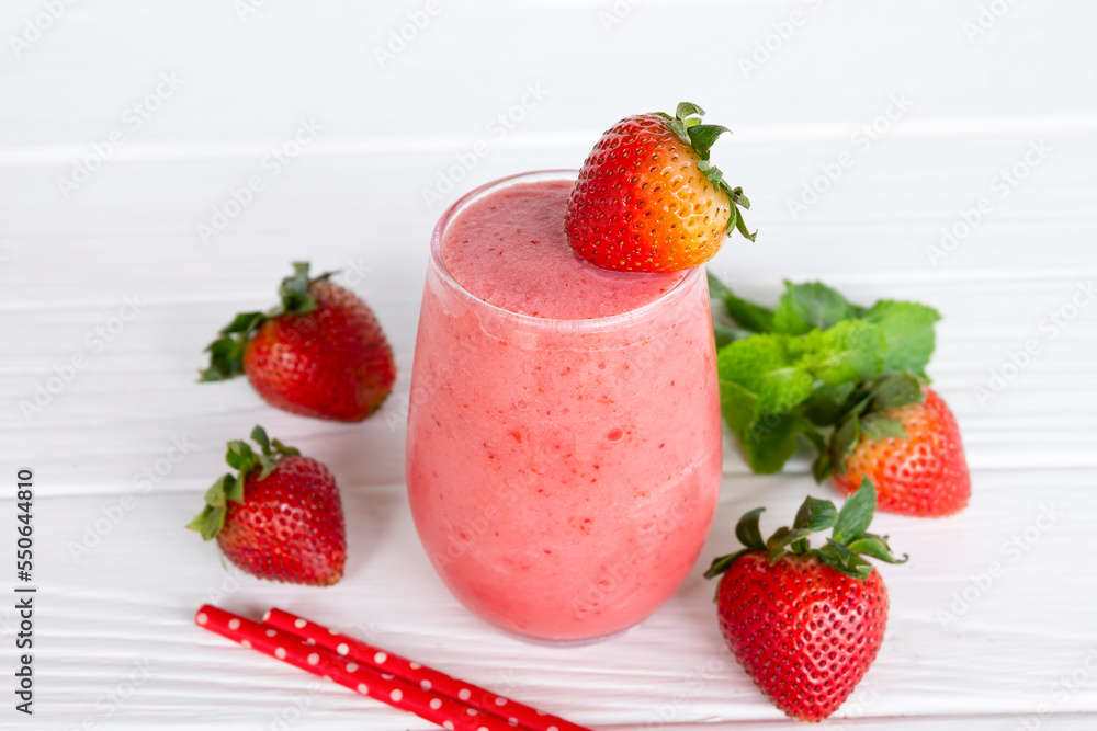 Strawberry yogurt fruit juice smoothie pink colorful fruit juice milkshake blend beverage healthy high protein the taste yummy In glass drink episode morning on white wood background.