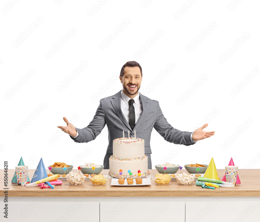 Man preparing for celebration with cake and party favors on a counter Man preparing for celebration with cake and party favors on a counter