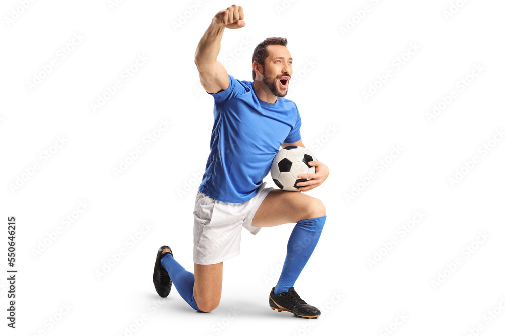 Football player with a ball kneeling and gesturing win Football player with a ball kneeling and gesturing win