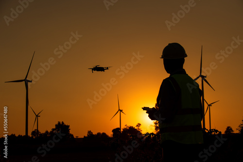 silhouette of a person control Drone on a sunset
