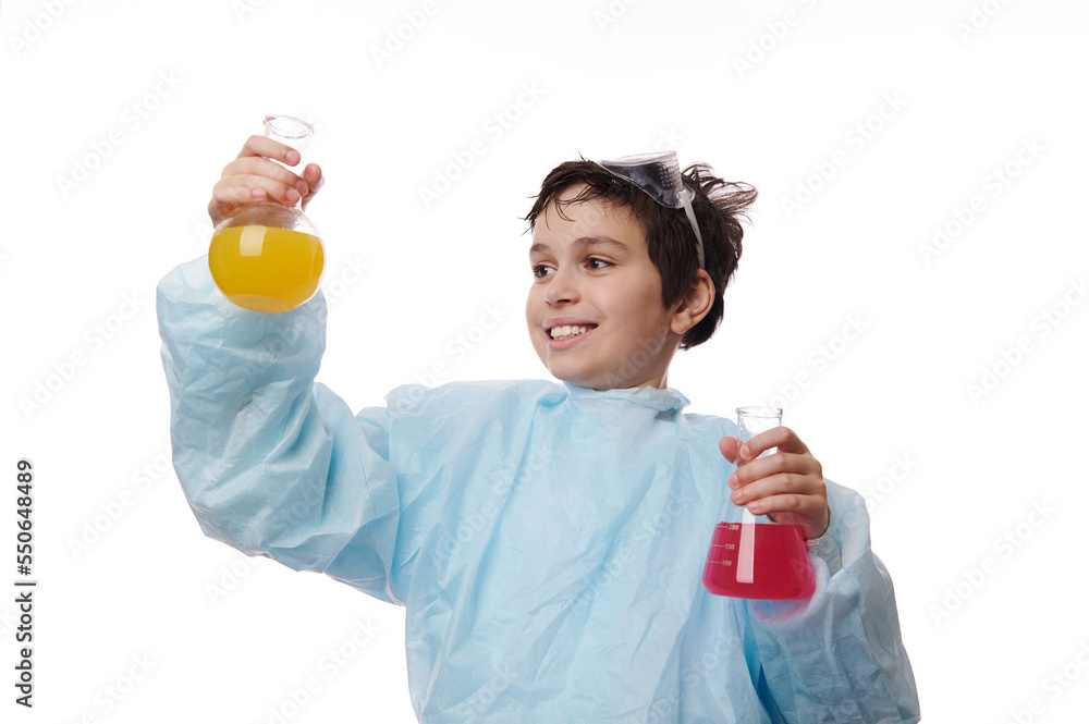 Chemistry lesson. Smart teenage schoolboy, a young chemist scientist doing scientific experiment with colored chemical fluid, isolated on white background. Concept of job and education. Copy ad space Chemistry lesson. Smart teenage schoolboy, a young chemist scientist doing scientific experiment with colored chemical fluid, isolated on white background. Concept of job and education. Copy ad space