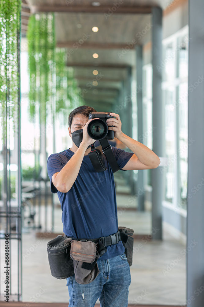 Male photographer with a large professional camera