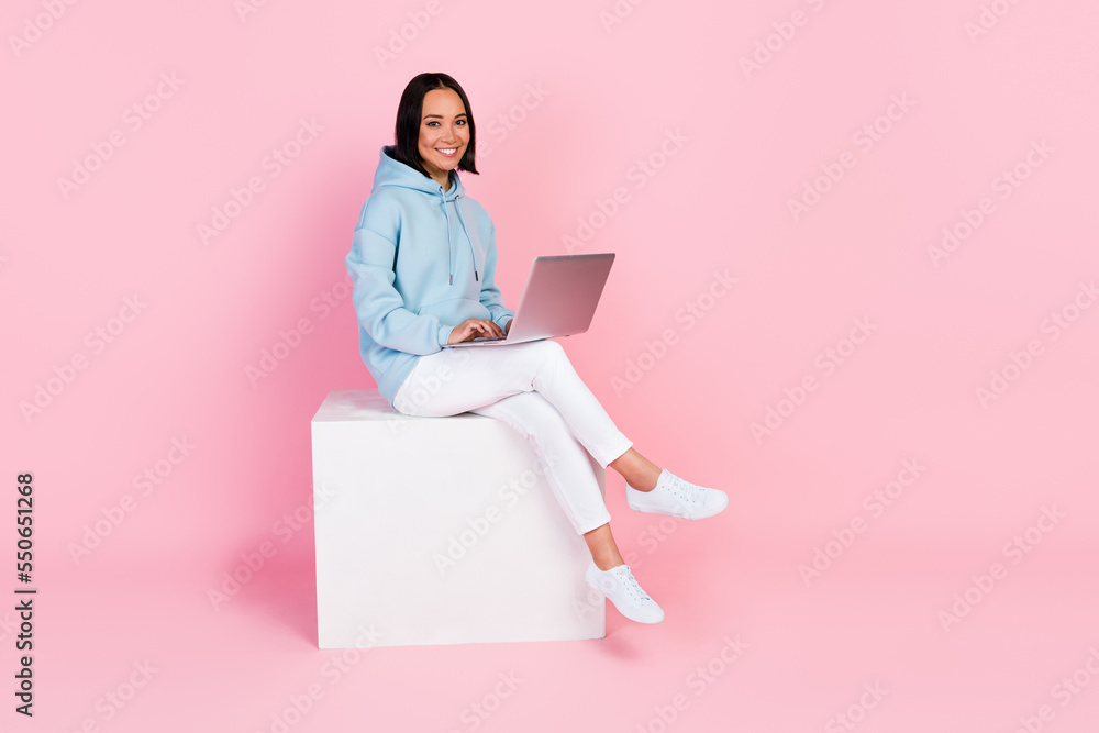 Full length photo of adorable cute lady sitting white figure typing sms message enjoying modern device isolated on pink color background Full length photo of adorable cute lady sitting white figure typing sms message enjoying modern device isolated on pink color background