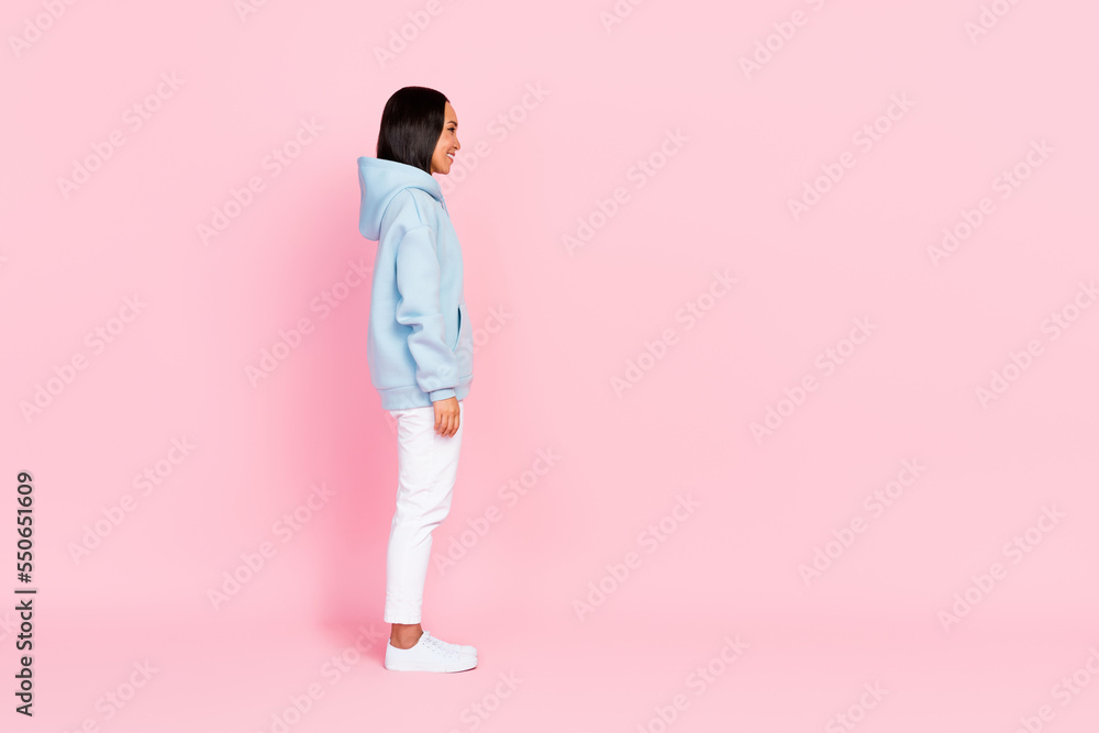 Fototapeta premium Profile side full length photo of cheerful adorable lady wear blue comfort clothes look empty space isolated on pink color background