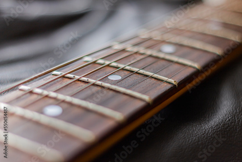 Guitar neck on the leather background