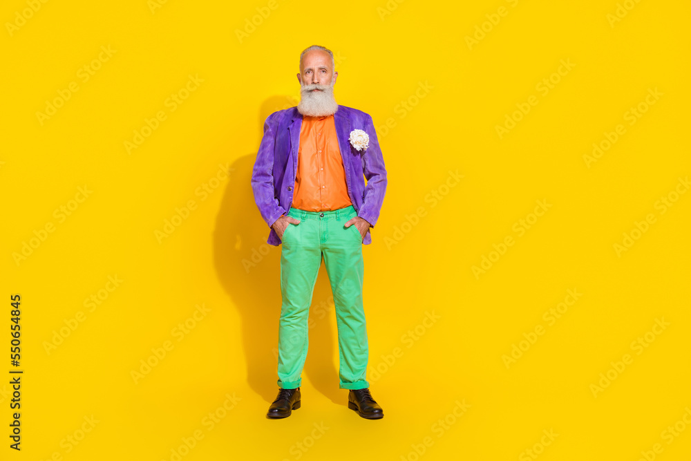 Full body photo of nice grandpa arms pockets nightclub dating theme party wear trendy colorful garment isolated on yellow color background Full body photo of nice grandpa arms pockets nightclub dating theme party wear trendy colorful garment isolated on yellow color background