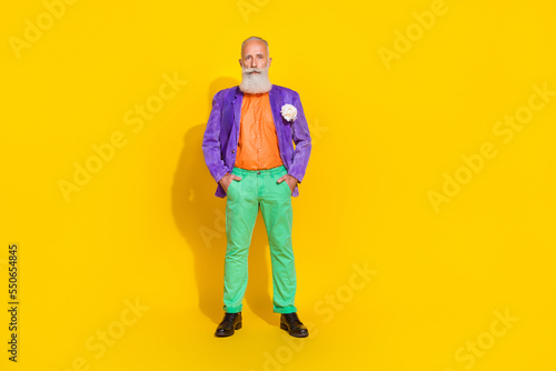 Full body photo of nice grandpa arms pockets nightclub dating theme party wear trendy colorful garment isolated on yellow color background