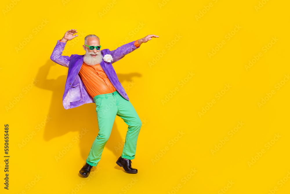 Full length photo of good mood positive guy dressed violet velvet jacket having disco fun empty space isolated yellow color background Full length photo of good mood positive guy dressed violet velvet jacket having disco fun empty space isolated yellow color background