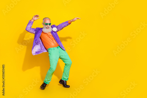 Full length photo of good mood positive guy dressed violet velvet jacket having disco fun empty space isolated yellow color background