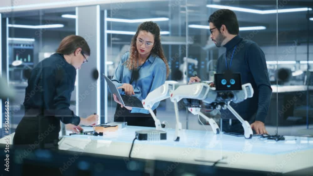 Young Team of Smart Diverse Multicultural Engineers Building and Developing a Robot Dog Concept. High Tech Research Factory with Talented Professional Employees. Young Team of Smart Diverse Multicultural Engineers Building and Developing a Robot Dog Concept. High Tech Research Factory with Talented Professional Employees.