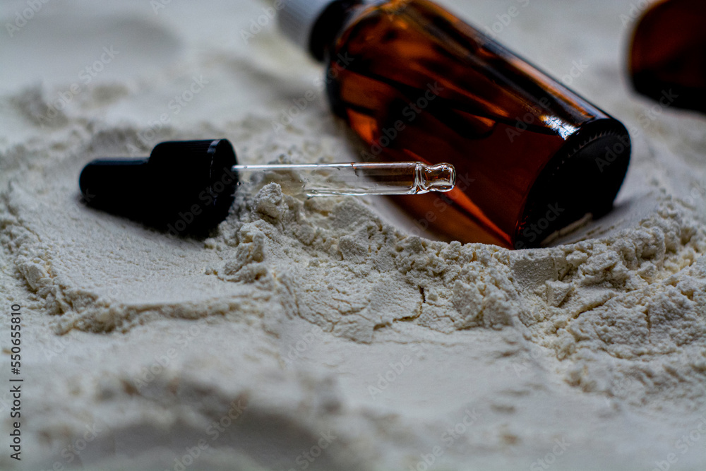 Natural cosmetics face oil in brown bottle on the sand