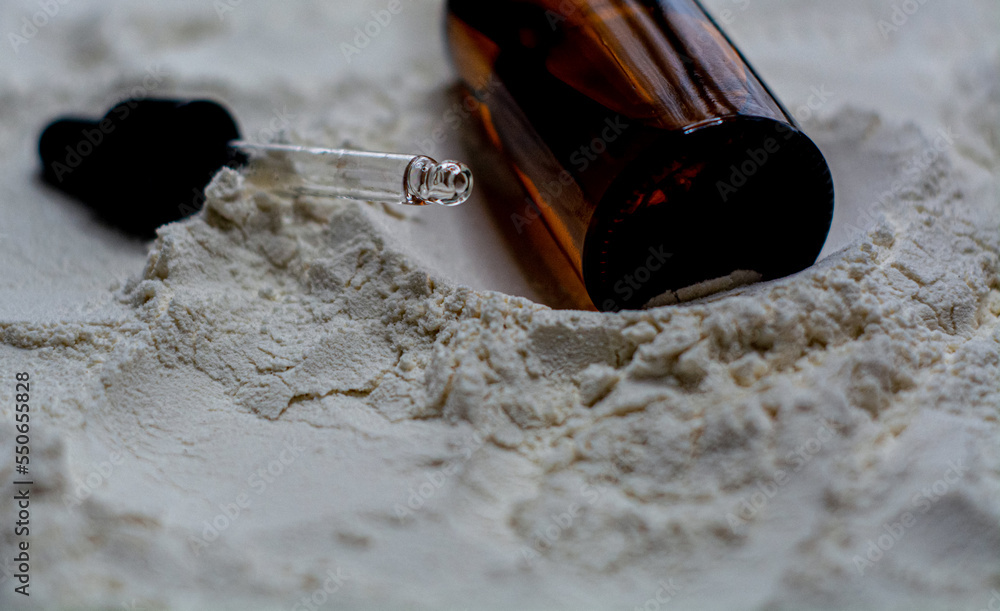 Natural cosmetics face oil in brown bottle on the sand