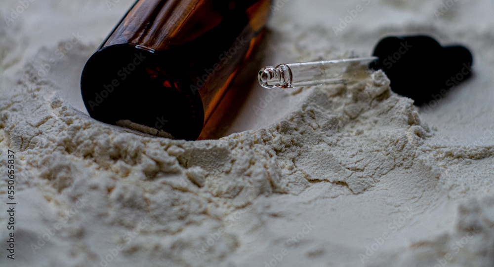 Natural cosmetics face oil in brown bottle on the sand