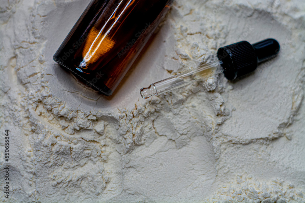 Natural cosmetics face oil in brown bottle on the sand