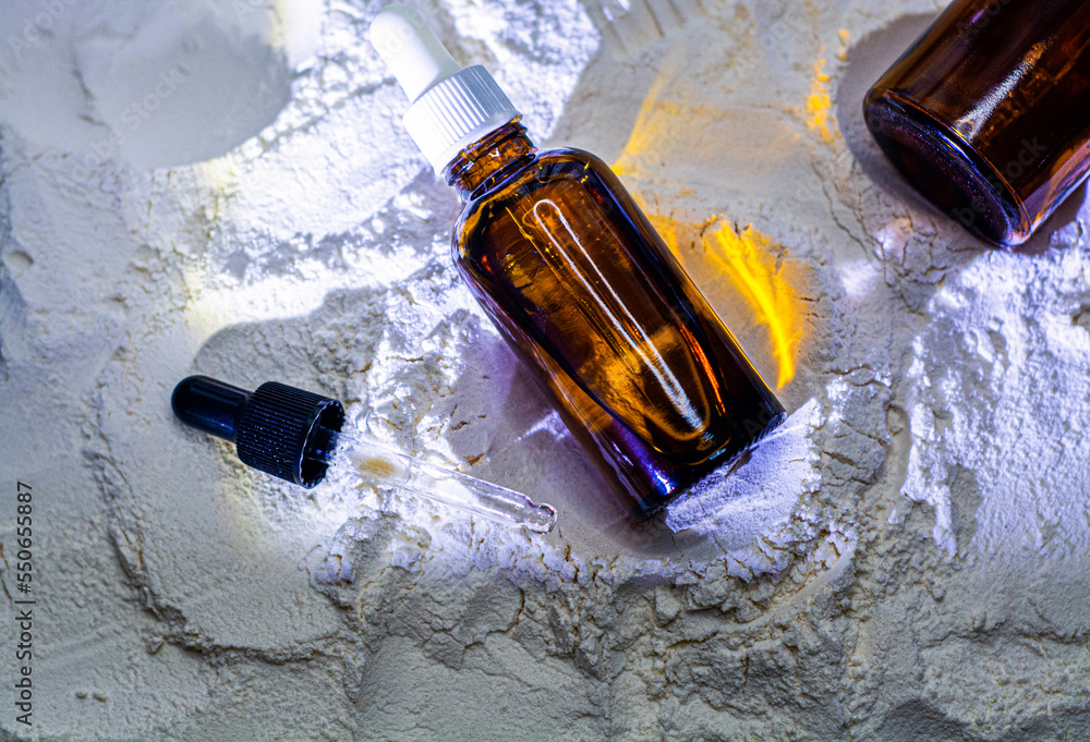 Natural cosmetics face oil in brown bottle on the sand