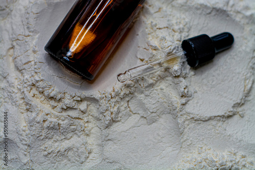 Obraz na płótnie Natural cosmetics face oil in brown bottle on the sand w salonie