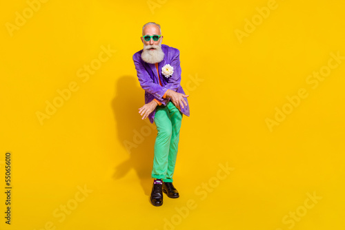 Full length photo of cheerful cool guy dressed violet velvet jacket having disco fun isolated yellow color background