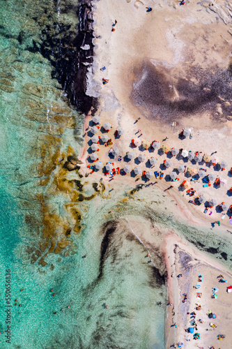 Aerial drone shot of beautiful turquoise beach with pink sand Elafonissi, Crete, Greece. Best beaches of Mediterranean, Elafonissi beach, Crete, Greece. Famous Elafonisi beach on Greece island, Crete. photo