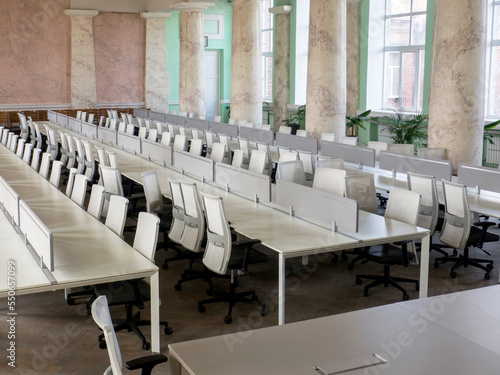 Empty conference room with white table and office chairs