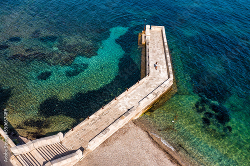 Kaiser Wilhelm's bridge and walkway a stone swim platform in Corfu, Greece photo