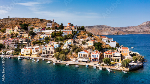 Aerial view of the beautiful greek island of Symi (Simi) with colourful houses and small boats. Greece, Symi island, view of the town of Symi (near Rhodes), Dodecanese. © daliu