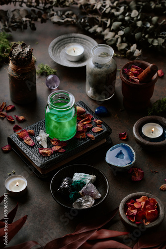 Witchcraft still life concept with potion  spell book  herbs ingredients candles and magical equipment