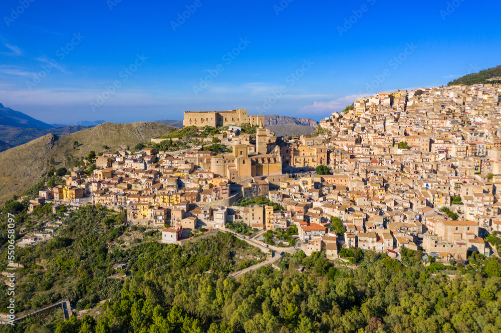 Caccamo, Sicily. Medieval Italian city with the Norman Castle in Sicily mountains, Italy. View of Caccamo town on the hill with mountains in the background, Sicily, Italy.