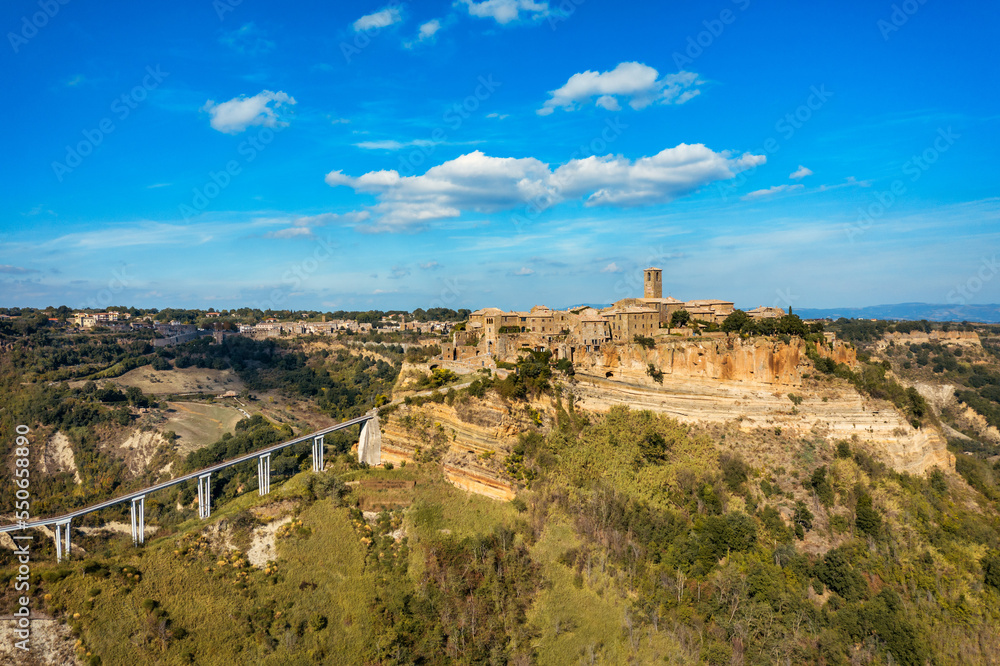 The famous Civita di Bagnoregio on a sunny day. Province of Viterbo, Lazio, Italy. Medieval town on the mountain, Civita di Bagnoregio, popular touristic stop at Tuscany, Italy.
