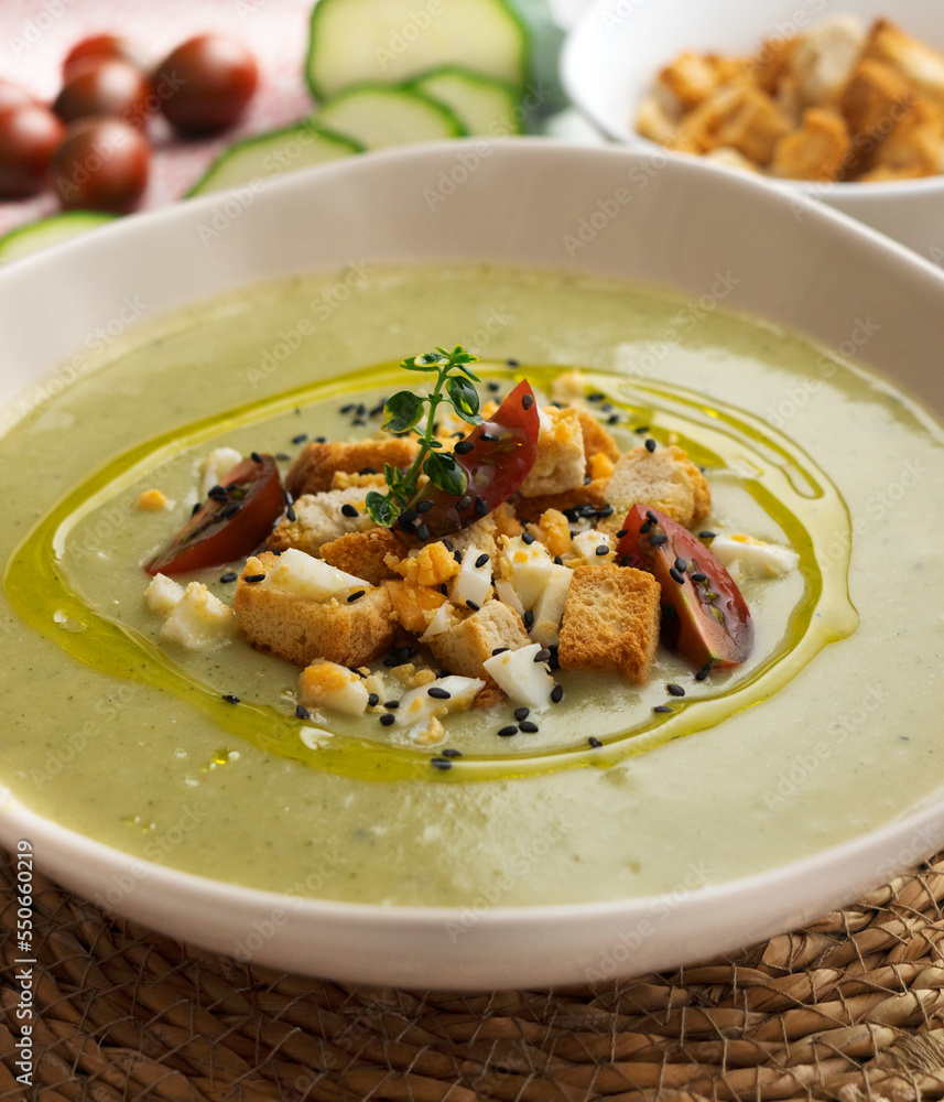 Vegetable cream with zucchini and potato. Typical Spanish tapa recipe decorated with croutons, hard-boiled egg and black sesame. Vegetable cream with zucchini and potato. Typical Spanish tapa recipe decorated with croutons, hard-boiled egg and black sesame.