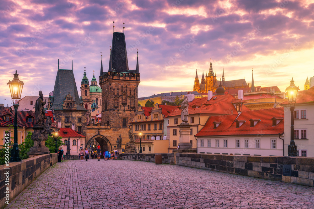 Charles Bridge in Prague at sunset. Prague, Czech Republic. Charles Bridge (Karluv Most) and Old Town Tower. Vltava River and Charles Bridge. Concept of world travel, sightseeing and tourism.