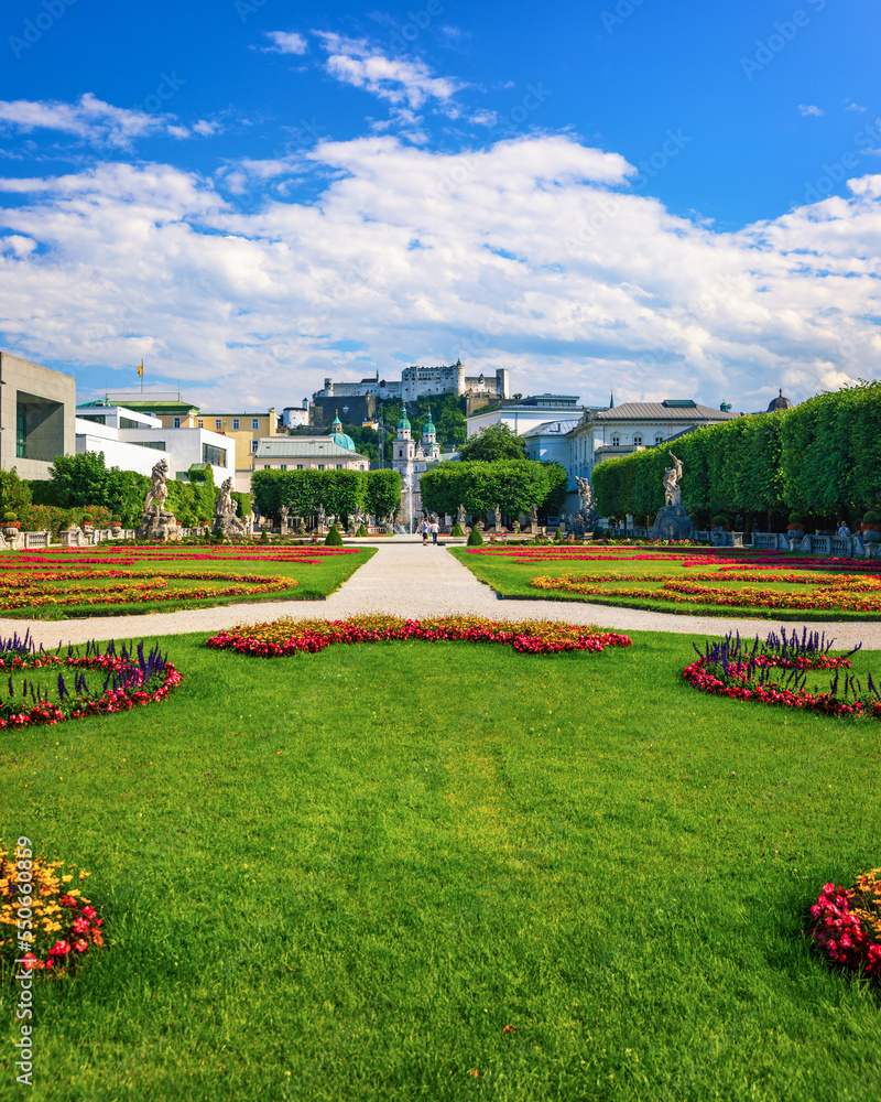 Obraz premium Beautiful view of famous Mirabell Gardens with the old historic Fortress Hohensalzburg in the background in Salzburg, Austria. Famous Mirabell Gardens with historic Fortress in Salzburg, Austria.