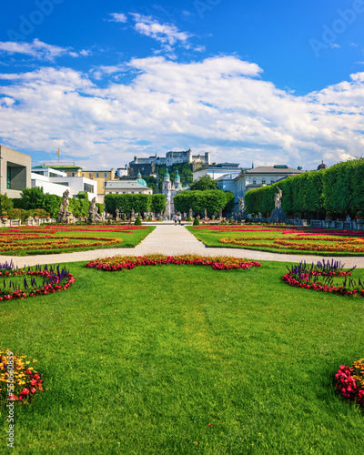 Beautiful view of famous Mirabell Gardens with the old historic Fortress Hohensalzburg in the background in Salzburg, Austria. Famous Mirabell Gardens with historic Fortress in Salzburg, Austria.