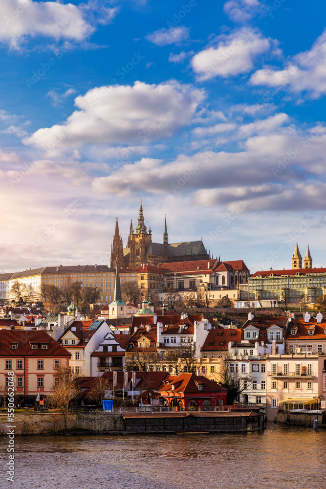 Obraz premium Prague Castle, Charles Bridge and boats on the Vltava river. View of Hradcany Prague Castle, Charles Bridge and a boats on the Vltava river in the capital of the Czechia.