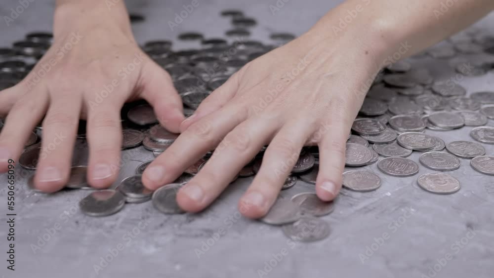 Greedy Female Hands are Stirring a Pile of Scattered Ukrainian Coins on Table. A scattering of Ukrainian silver five-cent, coins. Human greed. Financial crisis, budget savings, money accumulation. 4K. Greedy Female Hands are Stirring a Pile of Scattered Ukrainian Coins on Table. A scattering of Ukrainian silver five-cent, coins. Human greed. Financial crisis, budget savings, money accumulation. 4K.