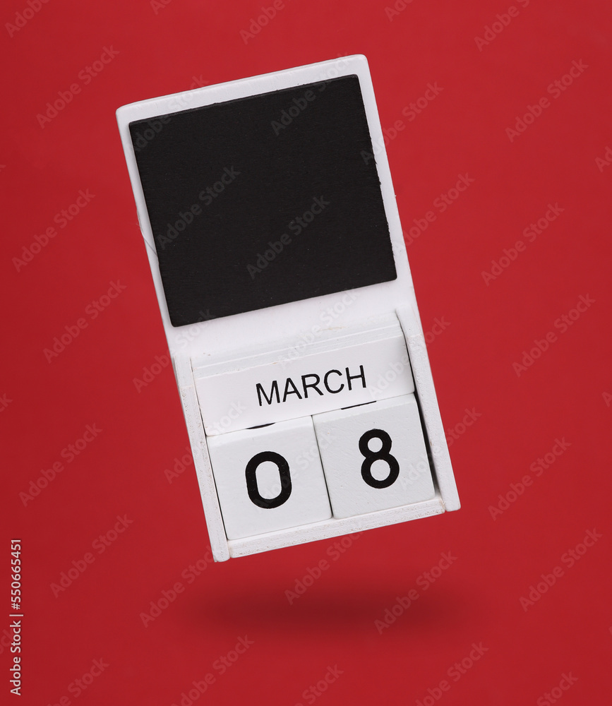 Wooden calendar with March 08 date levitating on red background. World Women's Day Wooden calendar with March 08 date levitating on red background. World Women's Day