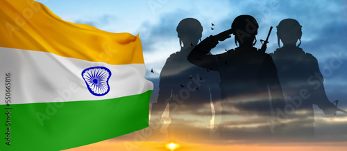 Silhouette of soldiers with India flag on a background the sky
