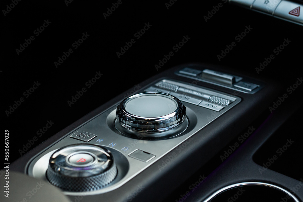 Drive selector button. Car interior, offroad drive controller closeup view. Wheel drive selection. Four-Wheel Drive transmission selection system.