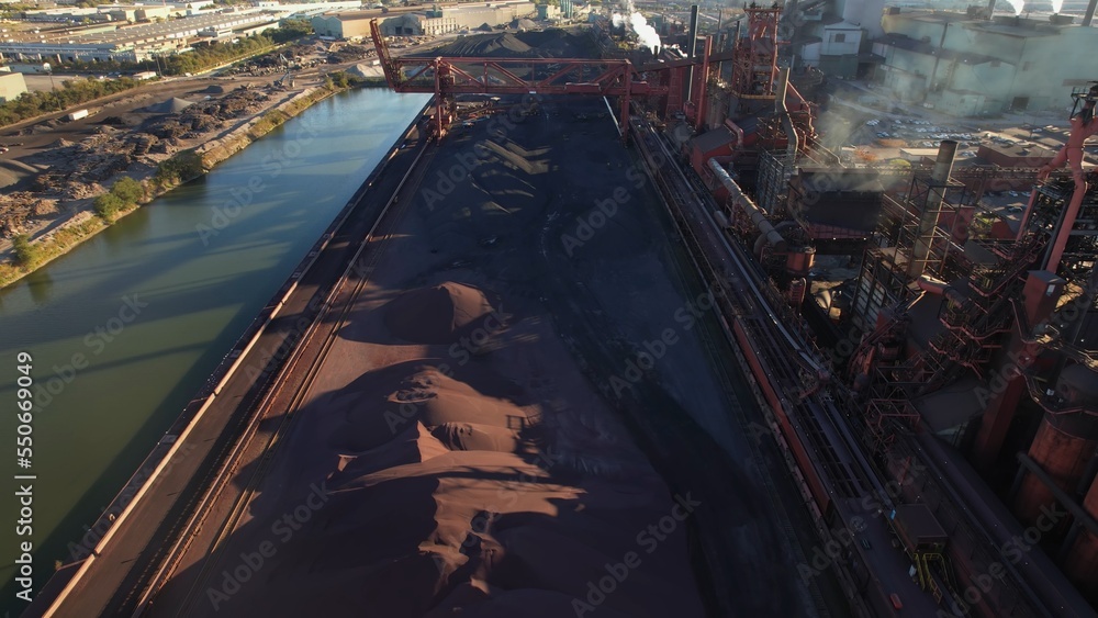 Steel manufacture factory urban area. Storage of iron ore, compound of iron, and other minerals make high quality flat carbon steel. Steel used in automotive, energy, packaging and construction.