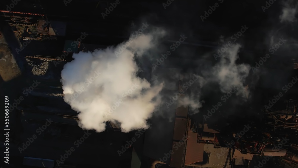 Dirty dark smokestack exhaust gases slow motion. Industrial zone and urban manufacturing. Pipe with thick white cloudy smoke. Climate change ecology and net zero emissions concept.