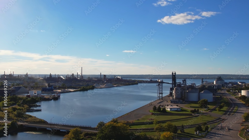 Steel factory aerial. Industry metallurgical plant at golden hour. Heavy industrial plant facility make steel with blast and electric furnace. Steel used in auto, energy, packaging and construction.