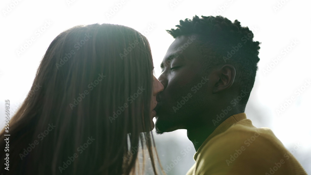 Young interracial couple kissing outside. Black man with white ...