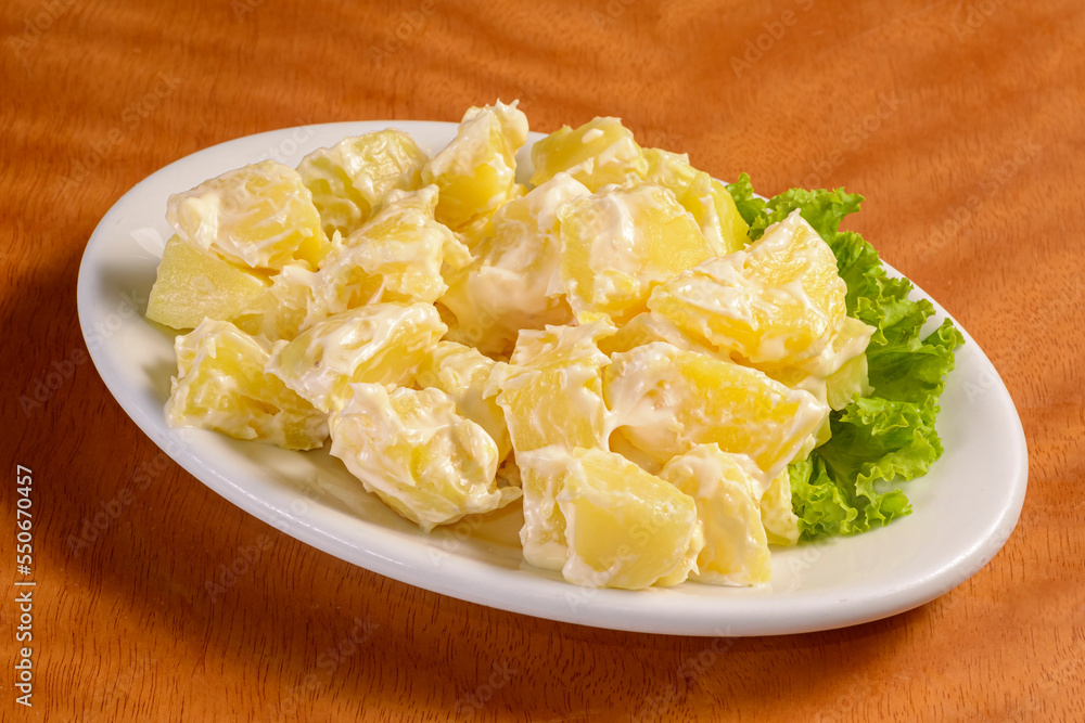 Potato salad mayonnaise in white bowl on wooden background. Potato salad mayonnaise in white bowl on wooden background.