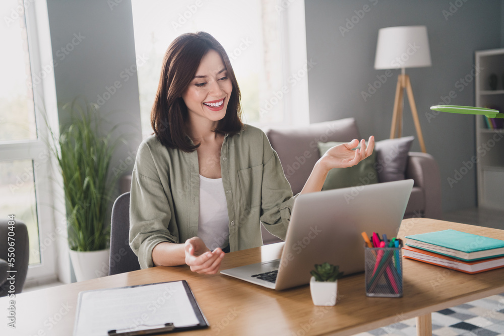 Naklejka premium Portrait of positive pretty lawyer girl sit chair use wireless netbook speak chatting video call modern bright room indoors